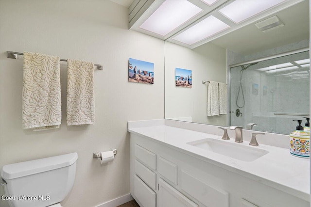 bathroom featuring vanity, toilet, and a shower with door