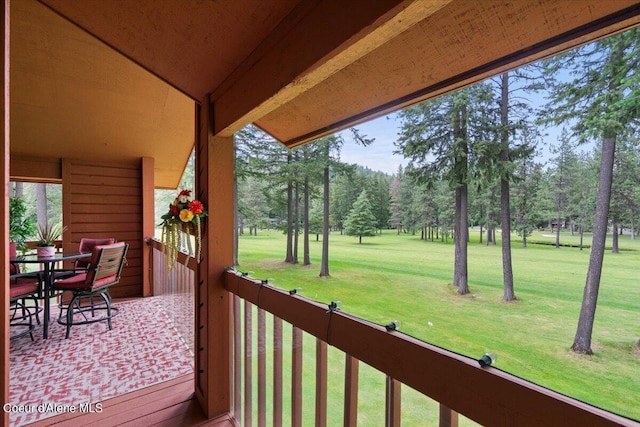 wooden terrace featuring a lawn