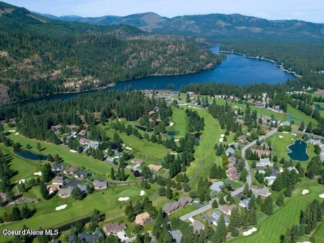 birds eye view of property with a water and mountain view