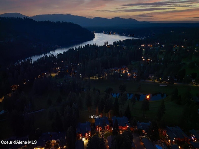 aerial view at dusk with a water and mountain view