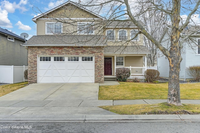 view of front property with a garage, covered porch, and a front lawn