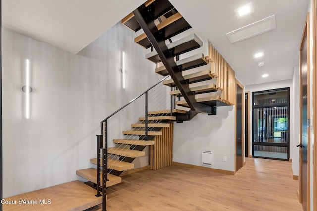 stairs featuring hardwood / wood-style flooring