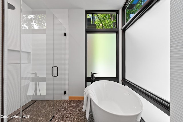 bathroom featuring independent shower and bath