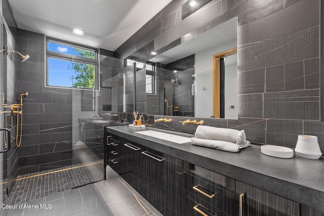 bathroom with walk in shower, vanity, tile walls, and backsplash