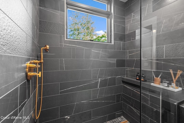 bathroom with tiled shower