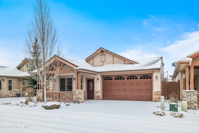 craftsman inspired home featuring a garage and a porch