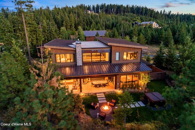 2763 E Lower Pasture Rd, Harrison, ID 83833 - rear view of house with an outdoor fire pit