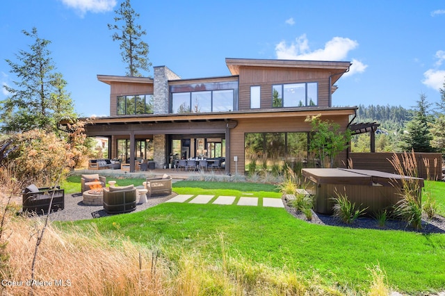 2763 E Lower Pasture Rd, Harrison, ID 83833 - back of property with an outdoor living space with a fire pit, a yard, a pergola, a hot tub, and a patio area