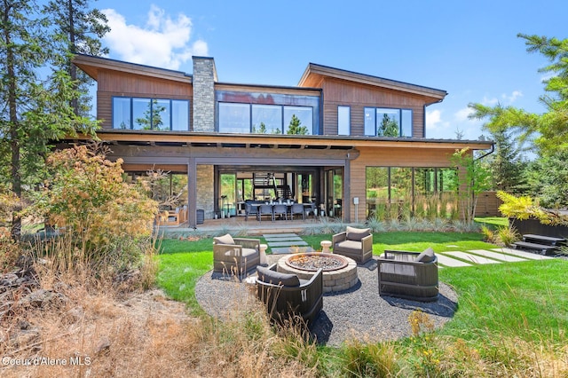 2763 E Lower Pasture Rd, Harrison, ID 83833 - rear view of house with a patio, a yard, and an outdoor living space with a fire pit