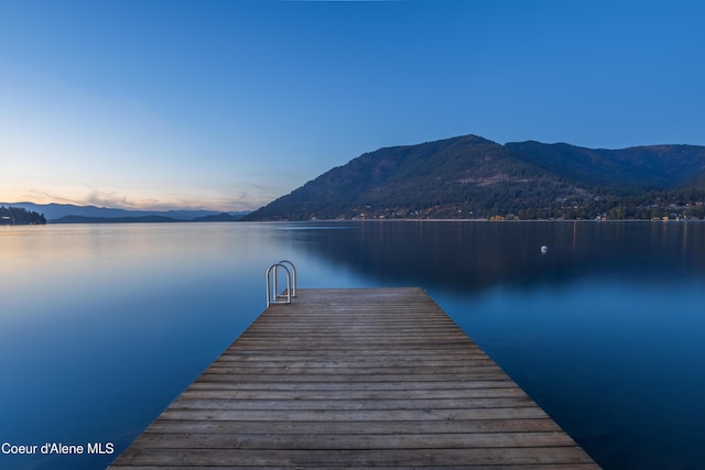 view of dock featuring a water and mountain view