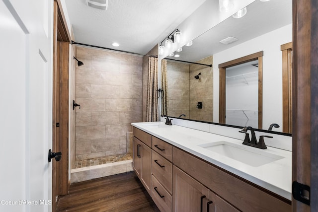 bathroom with vanity, hardwood / wood-style floors, a textured ceiling, and a shower with shower curtain