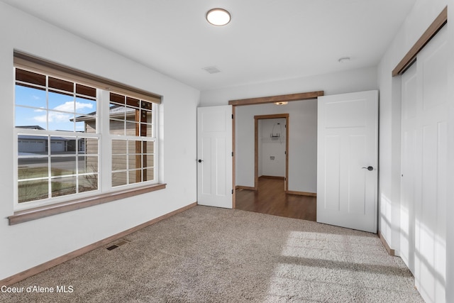 unfurnished bedroom featuring carpet flooring and a closet