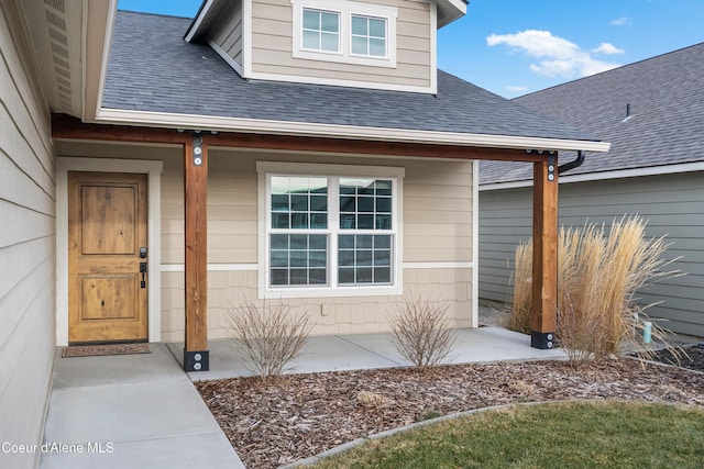 view of exterior entry with a porch