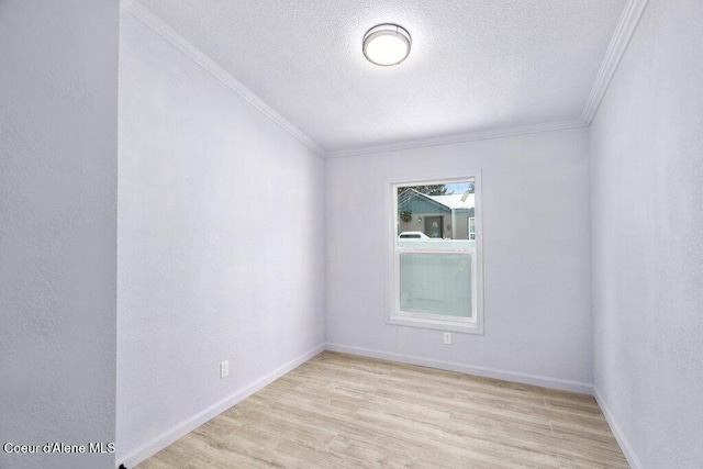 spare room with ornamental molding, a textured ceiling, and light wood-type flooring