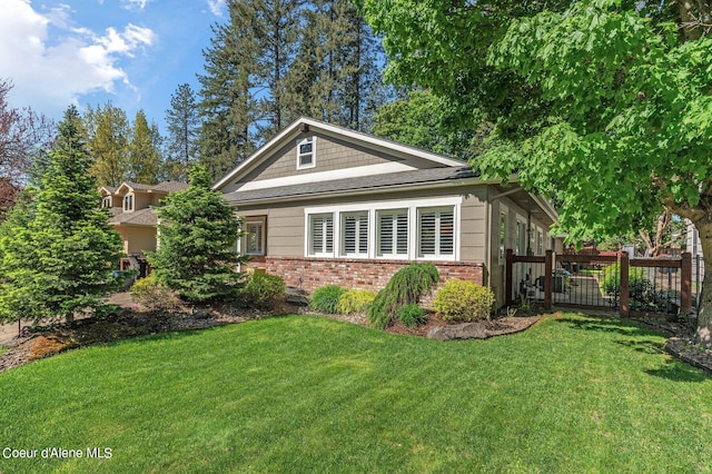 view of side of property with a lawn