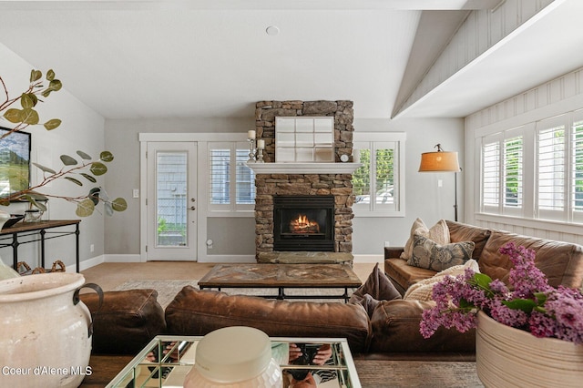 living room with lofted ceiling, carpet flooring, and a fireplace