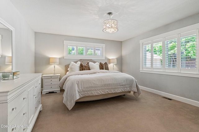 carpeted bedroom with multiple windows