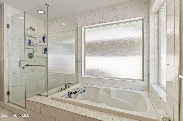 bathroom with shower with separate bathtub