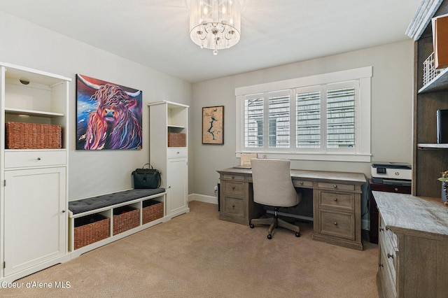 carpeted home office with a chandelier