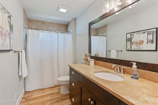 bathroom with a shower with shower curtain, vanity, toilet, and hardwood / wood-style floors