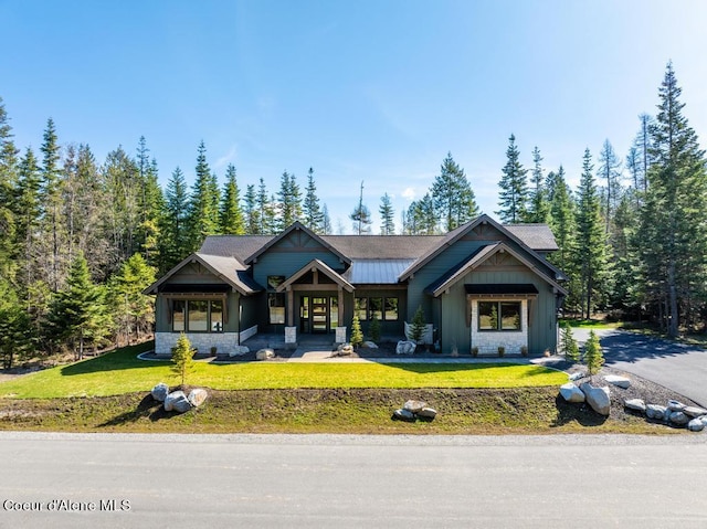 craftsman house featuring a front yard and french doors