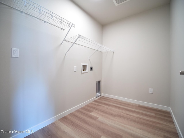 laundry room with hookup for a washing machine, light hardwood / wood-style floors, and hookup for an electric dryer