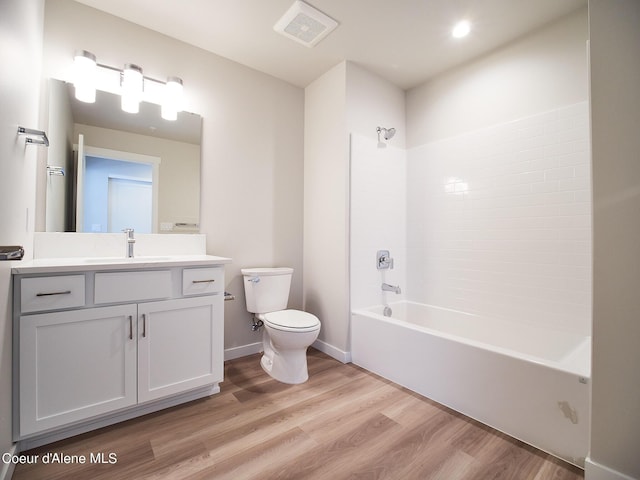 full bathroom featuring shower / bathing tub combination, vanity, wood-type flooring, and toilet