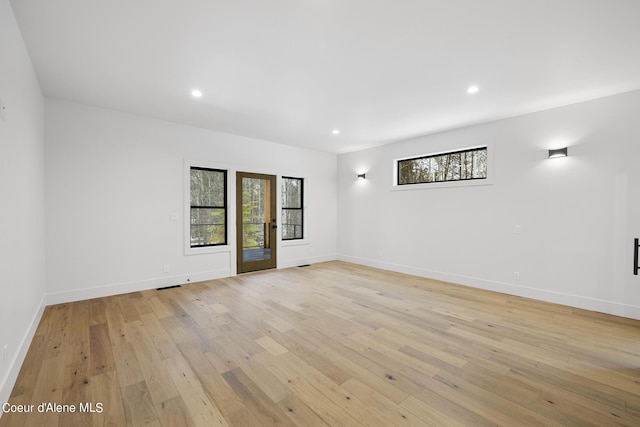 empty room with light hardwood / wood-style flooring