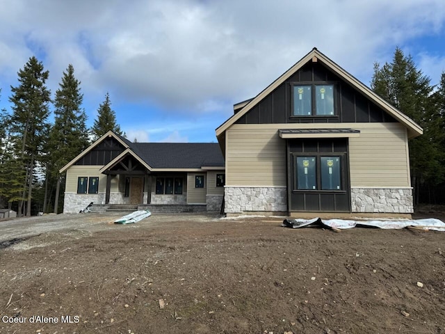 view of front of property with stone siding and board and batten siding