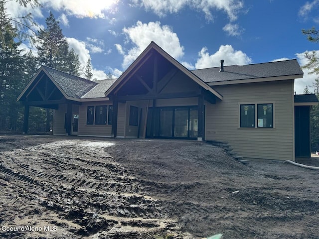 chalet / cabin featuring roof with shingles