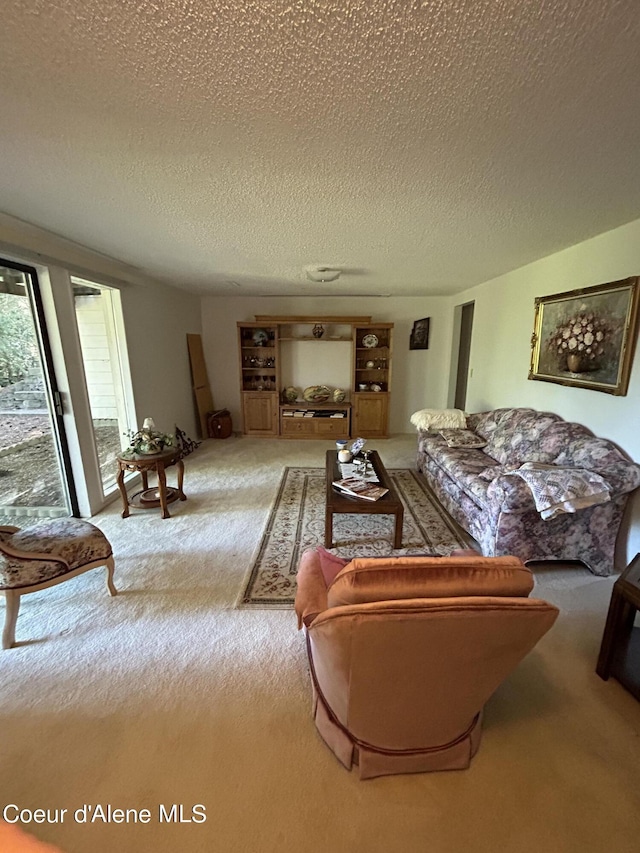 carpeted living room featuring a textured ceiling