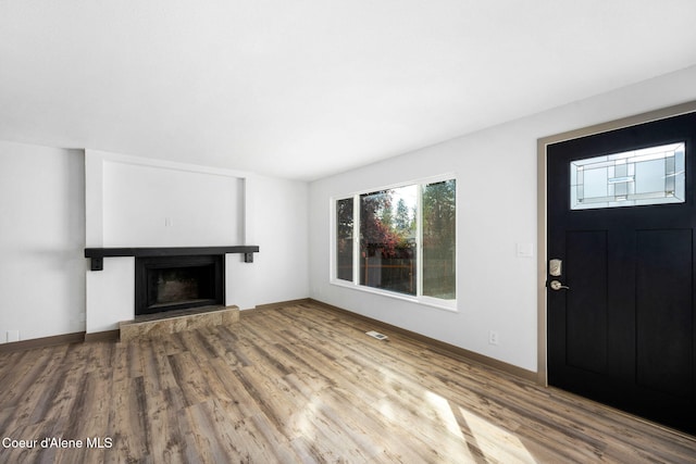 unfurnished living room with hardwood / wood-style flooring