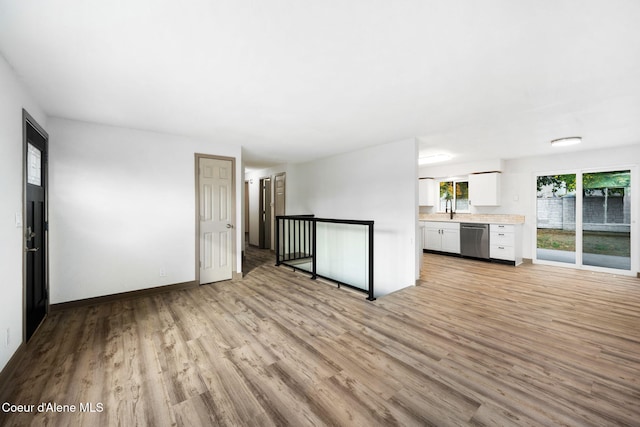 empty room featuring sink and light hardwood / wood-style floors