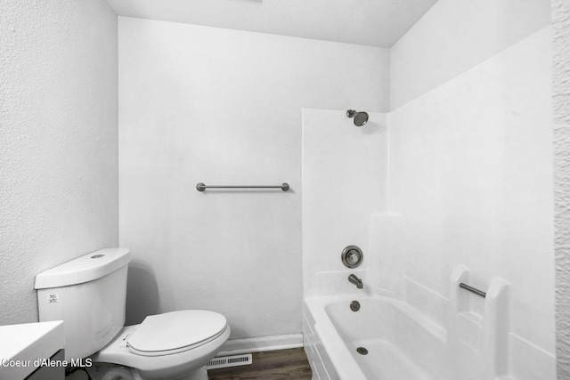 full bathroom with bathtub / shower combination, vanity, toilet, and hardwood / wood-style floors