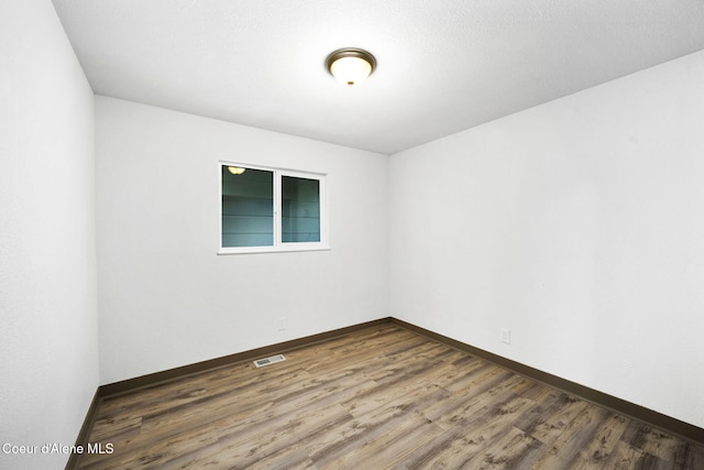 empty room featuring dark hardwood / wood-style flooring