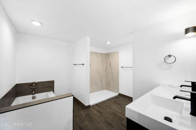 bathroom featuring wood-type flooring, vanity, and walk in shower