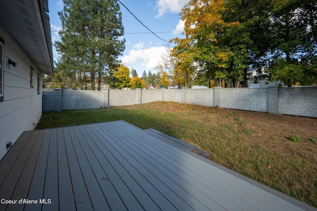 wooden terrace featuring a lawn