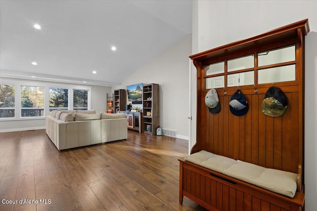 mudroom featuring dark wood-type flooring and vaulted ceiling