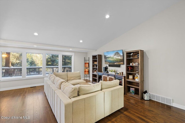 living room with vaulted ceiling and dark hardwood / wood-style floors