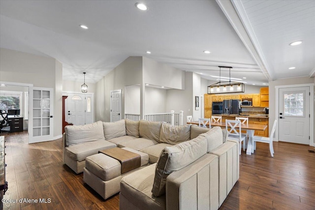 living room featuring lofted ceiling with beams and wood-type flooring