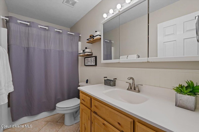 bathroom with vanity, tile patterned floors, and toilet