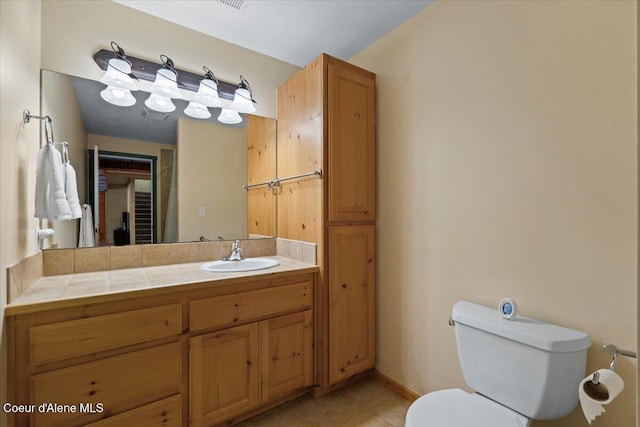 bathroom with vanity, tile patterned floors, and toilet