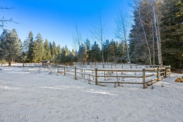 snowy yard with a rural view