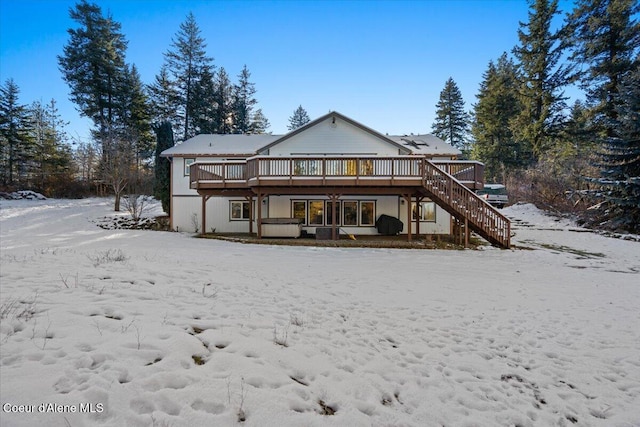 snow covered property featuring a wooden deck