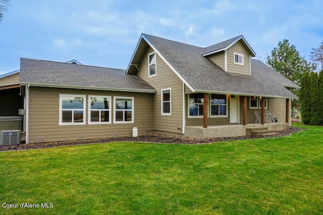 view of front facade with cooling unit, a porch, and a front lawn