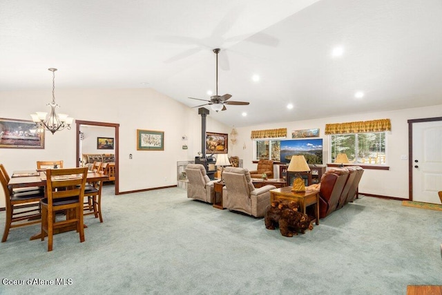 carpeted living room featuring lofted ceiling, a wood stove, and ceiling fan with notable chandelier