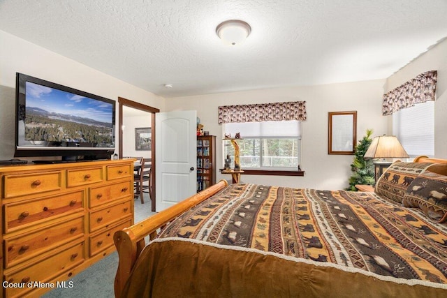 carpeted bedroom with a textured ceiling