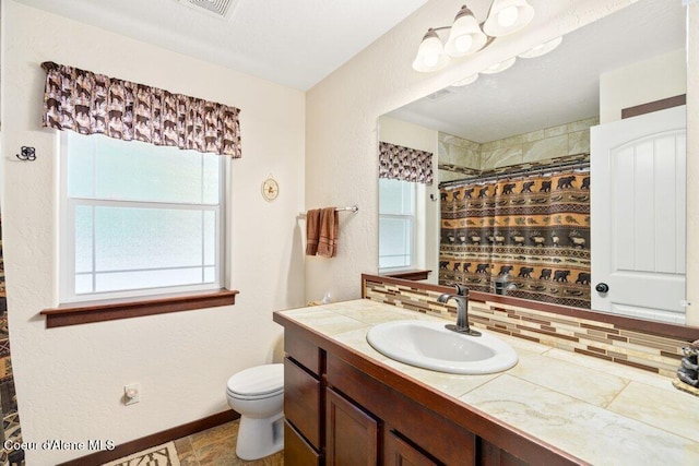 bathroom with vanity, decorative backsplash, toilet, and a shower with shower curtain