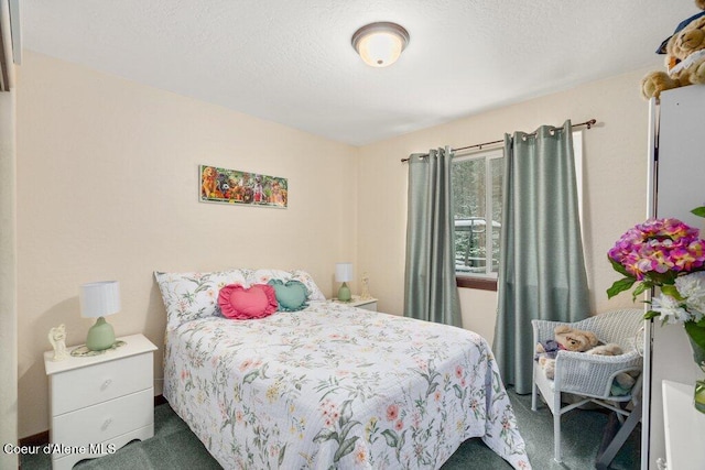 bedroom featuring a textured ceiling and dark colored carpet