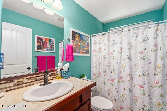 bathroom with vanity, toilet, and a shower with shower curtain